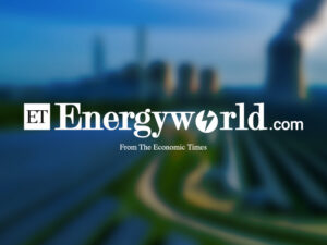 Economic Times EnergyWorld logo over a blurred photo of a coal power plant surrounded by a solar panel park