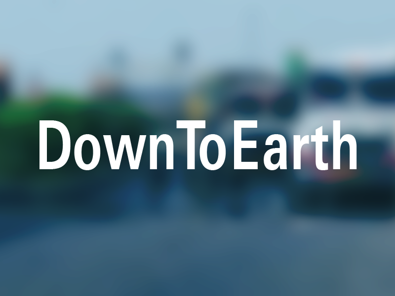 DownToEarth logo over a blurred photo of a road with heat waves showing and cars/trucks stopped